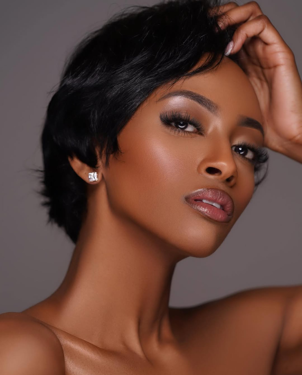 Close-up beauty portrait of a woman with short dark hair and soft glam lighting